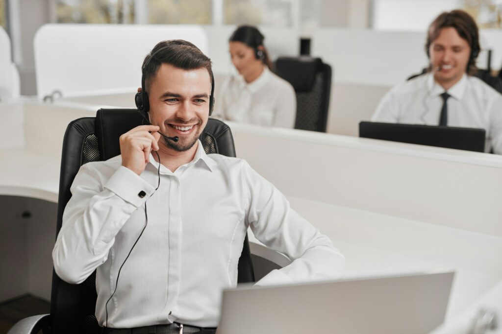 Cheerful male assistant speaking with client